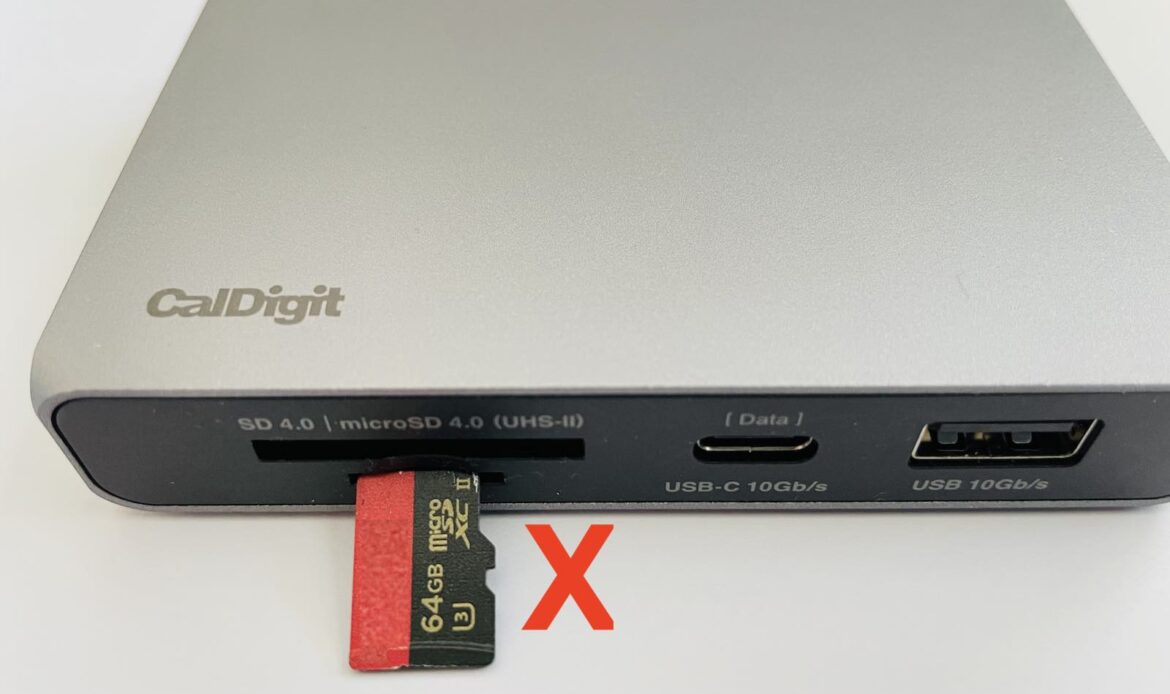 Image of the SOHO Dock with a microSD being inserted with the metal connections faced down and a red x indicating it is the incorrect way to insert the card.