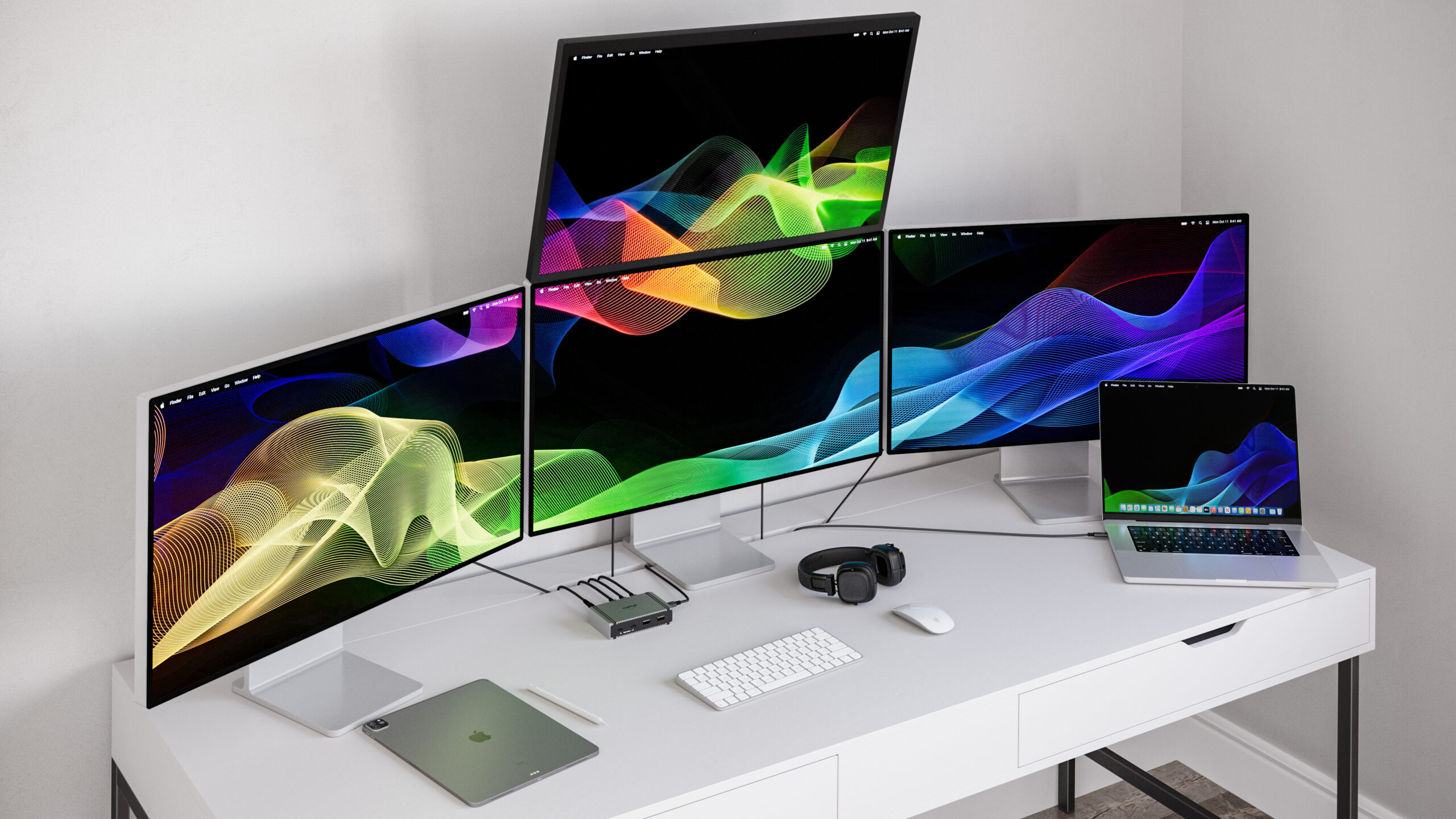 An image of the Element 5 Hub on a desk connected to a MacBook Pro and 4 displays.