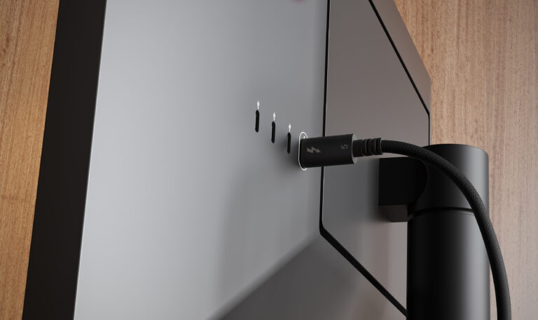 An image of the back of a monitor. The CalDigit Thunderbolt 5 Pro Cable 1.5m is connected to one of the ports on teh back of the monitor.